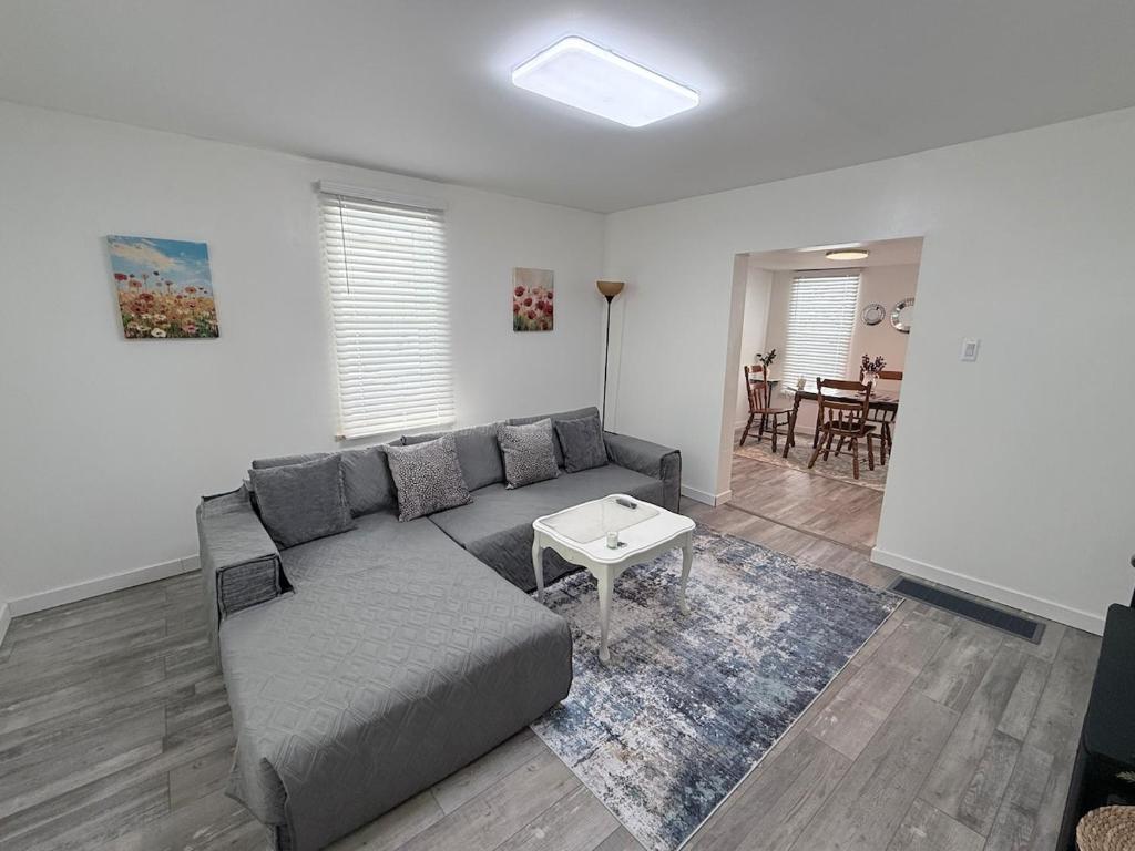 a living room with a couch and a table at Completely renovated for you Mountain View Cottage in Charleston