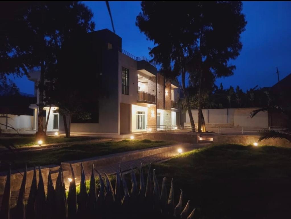 a house with lights in front of it at night at Ni HOME & RELAX in Ruhengeri