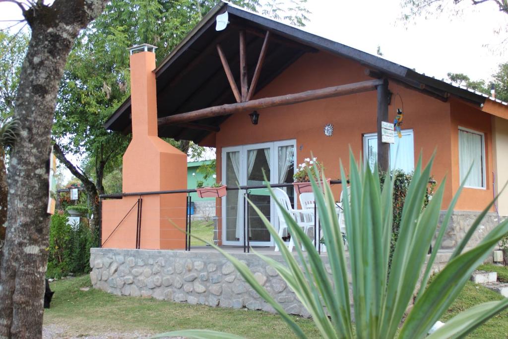 a small orange house with a chimney at Cabañas equipadas en Vaqueros - naturaleza y tranquilidad cerca de Salta in Vaqueros