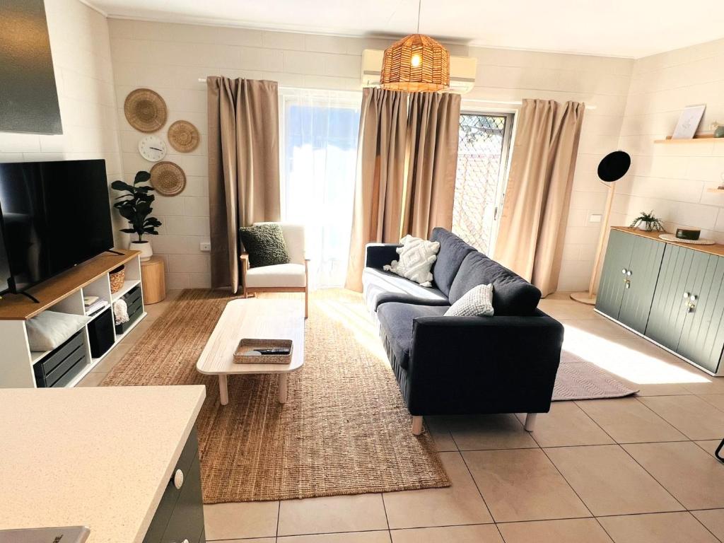 a living room with a couch and a tv at Another 'Your Place on Davidson!' in Mount Isa