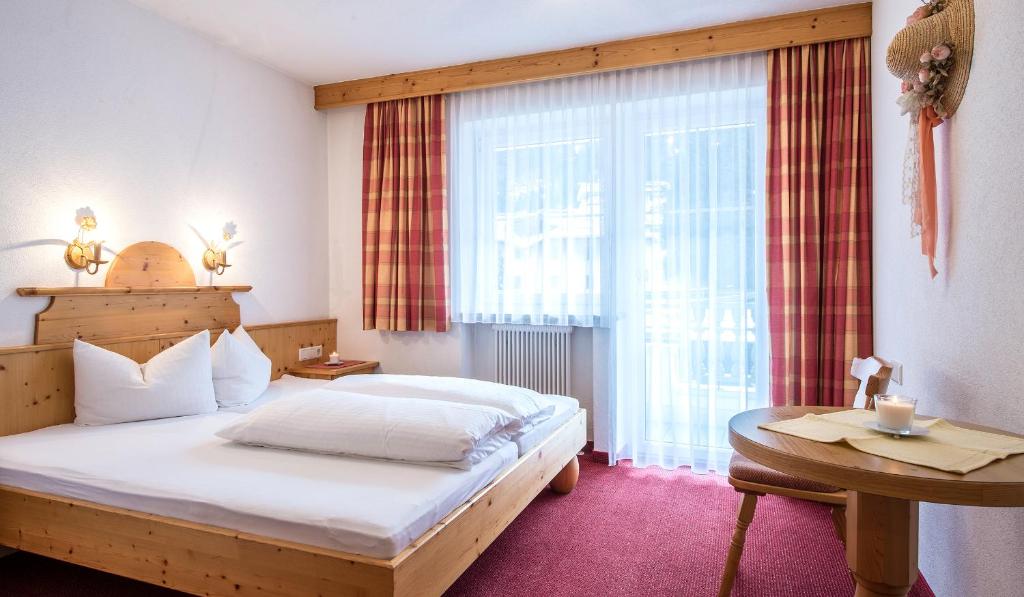 Postel nebo postele na pokoji v ubytování Apart Garni Elfrieda