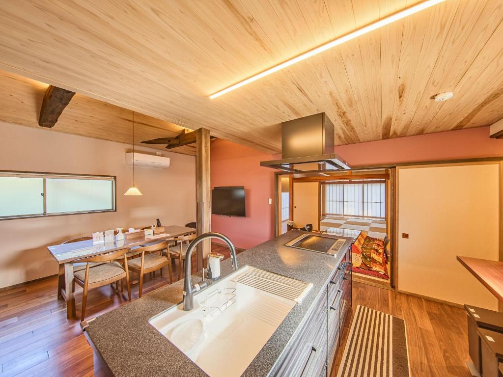 a kitchen with a sink and a dining table at 縁や出雲 in Taisha
