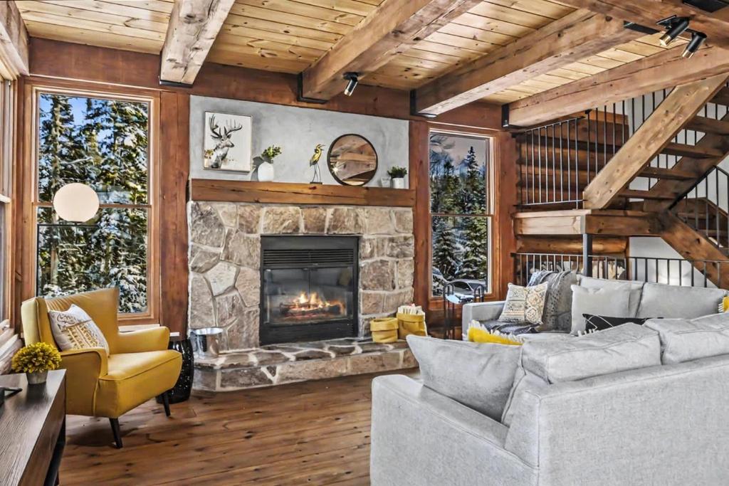 a living room with a couch and a fireplace at 4-Bedroom Chalet Fraternite in Lac-Superieur Tremblant in Lac-Superieur