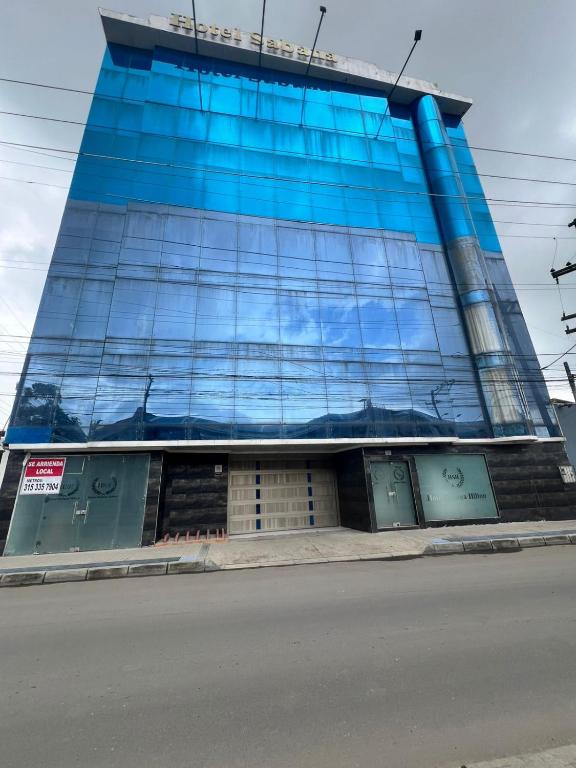 a building with blue glass windows on a street at Hotel Sabana Hilton in Madrid