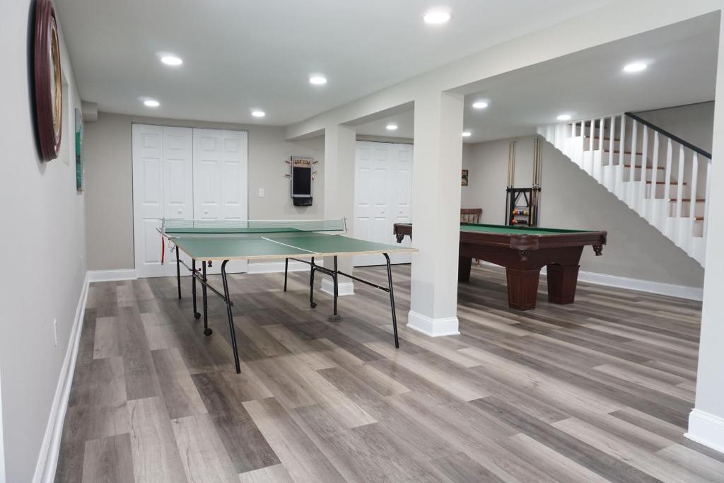 a room with a ping pong table and a pool table at Gateway Getaways in Hagerstown