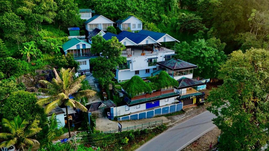 an aerial view of a large house in the forest at Bellavista Resort Munnar in Munnar