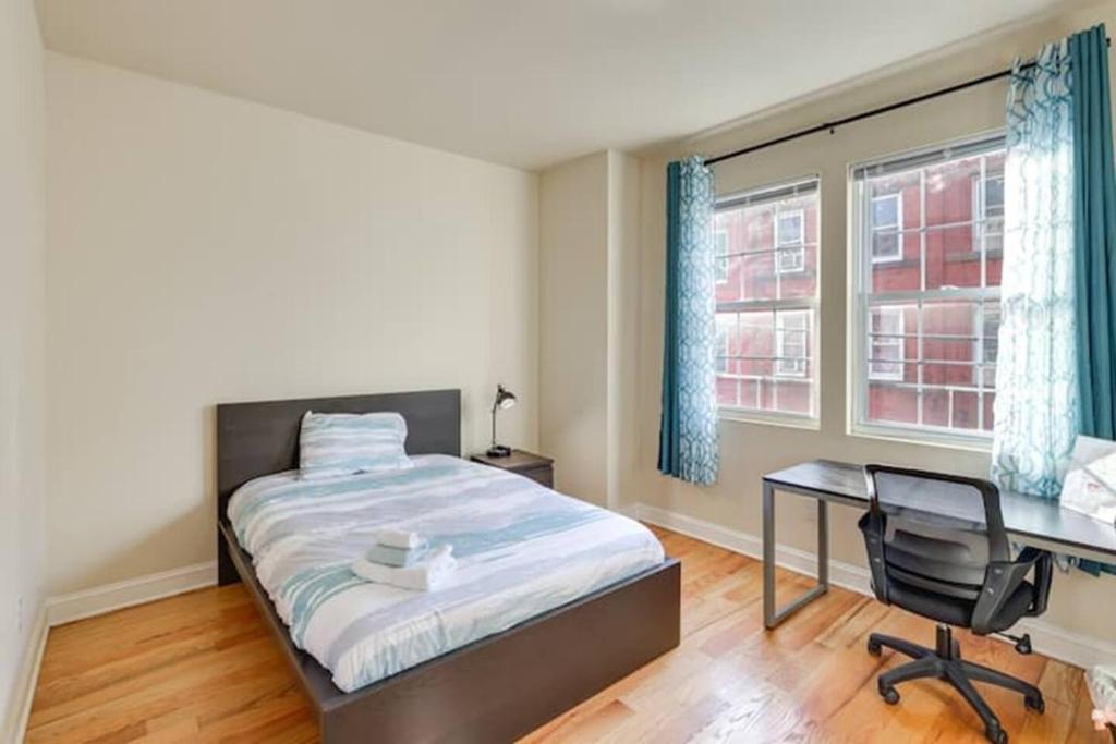 a bedroom with a bed and a desk and window at Private Room | Temple | Fast WiFi | Kitchen V in Philadelphia