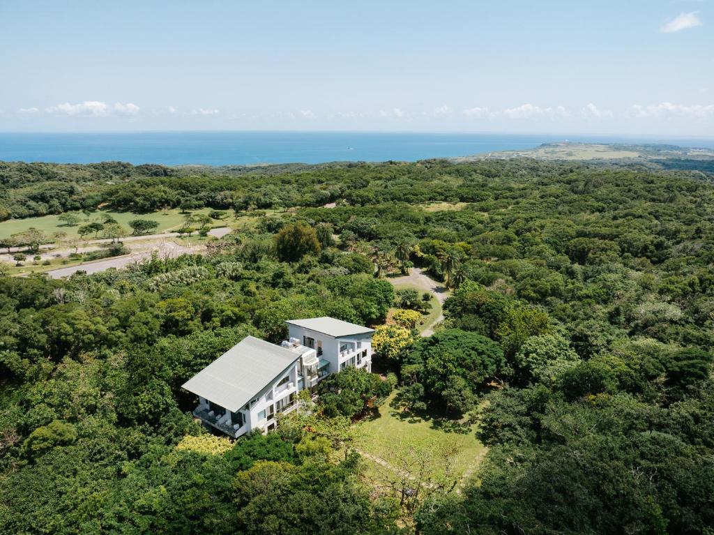 an aerial view of a white house in the forest at Toptai Kenting BY REINDEER in Kenting