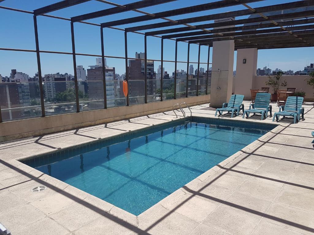 a swimming pool on top of a building at Ariston Hotel in Rosario
