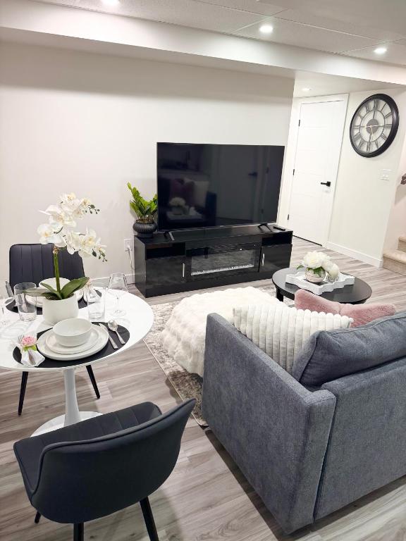 a living room with a couch and a table at Velvet and Rose Elegant Private 2BR Basement Suite in Winnipeg