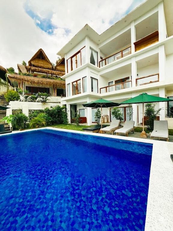 a house with a swimming pool in front of a house at Garden Hill Views in Kuta Lombok