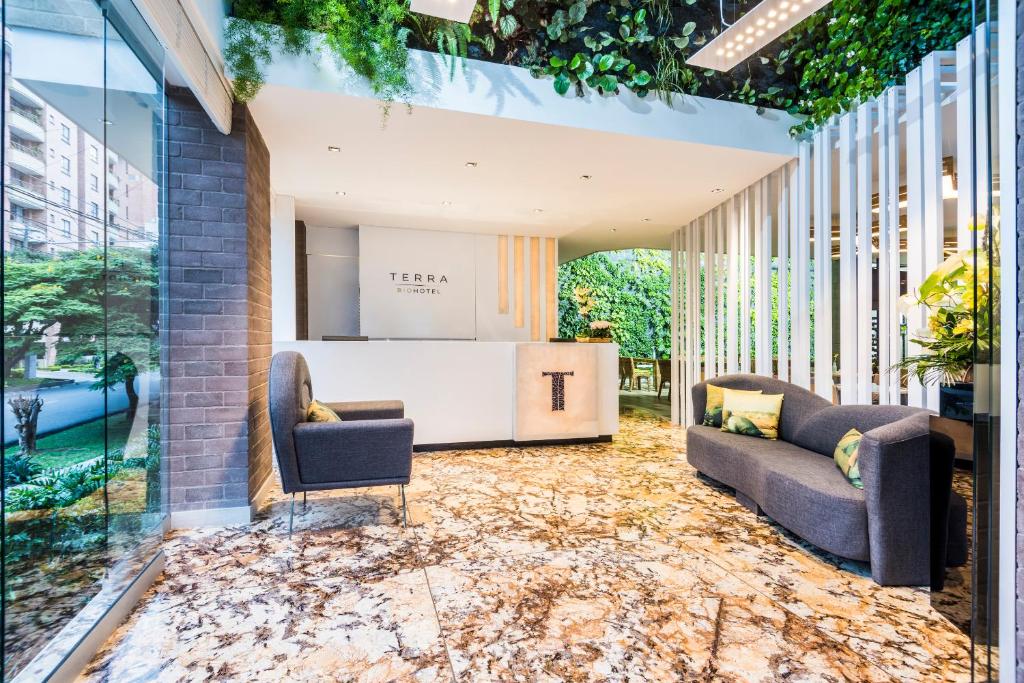 a lobby with a floor covered in leaves at Terra Biohotel in Medellín