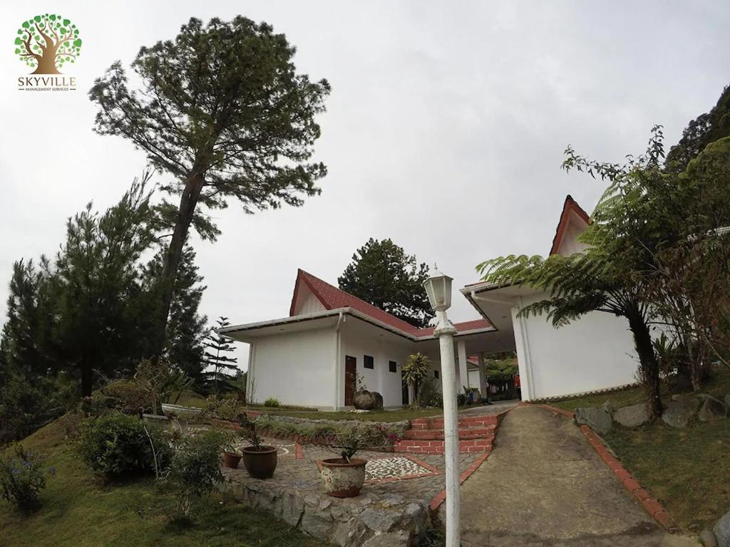 a small white house with a red roof at Skyville Zen Resort,Kundasang in Kampong Kundassan