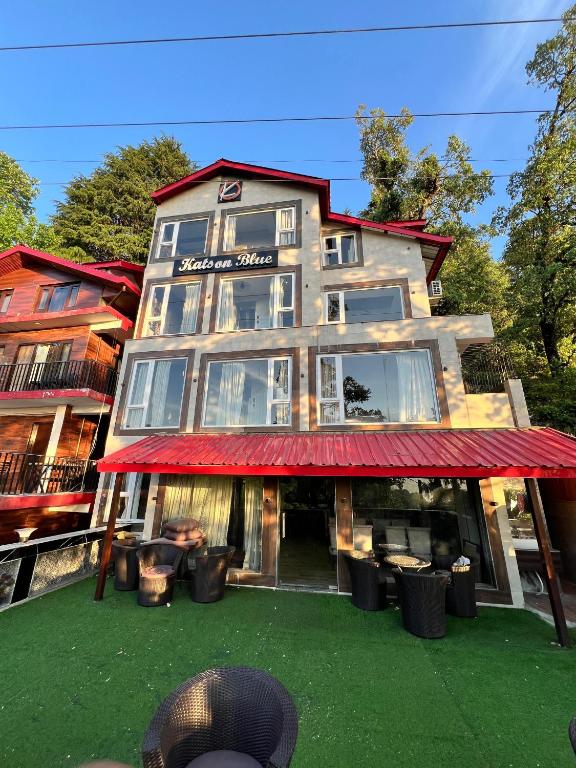 a building with a red awning in front of it at Katson Blue Dalhousie in Dalhousie