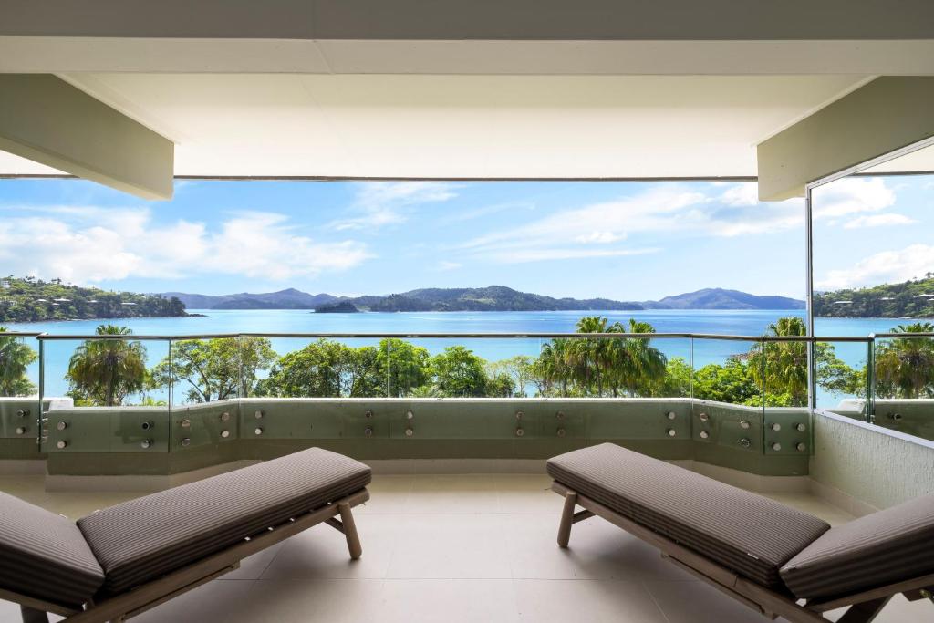 a balcony with a view of the water at Beach Lodges in Hamilton Island