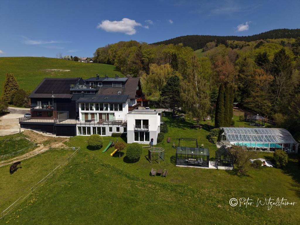 an aerial view of a large house on a green field at Pension Irlingerhof in Mondsee