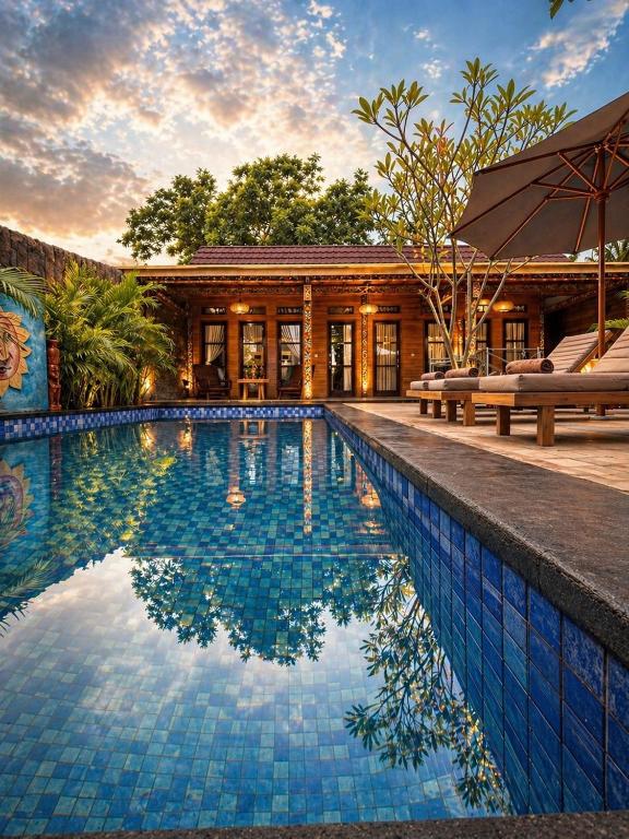 a swimming pool in front of a house at Namali Private Villa in Gili Trawangan