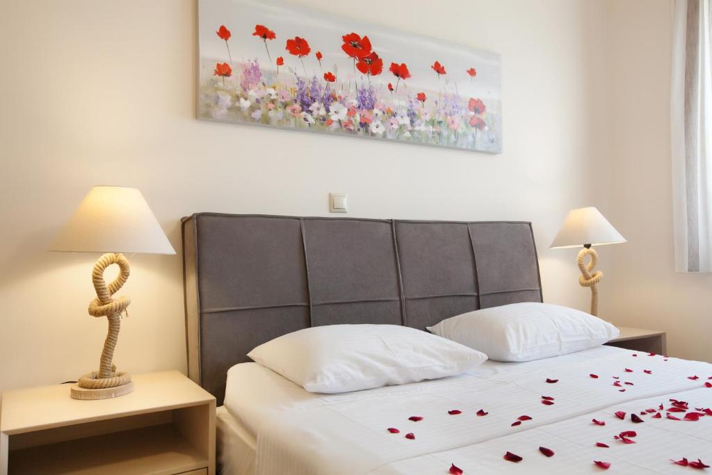 a bedroom with a bed with red flowers on it at Petra Thea Apartments 2 in Kalamata