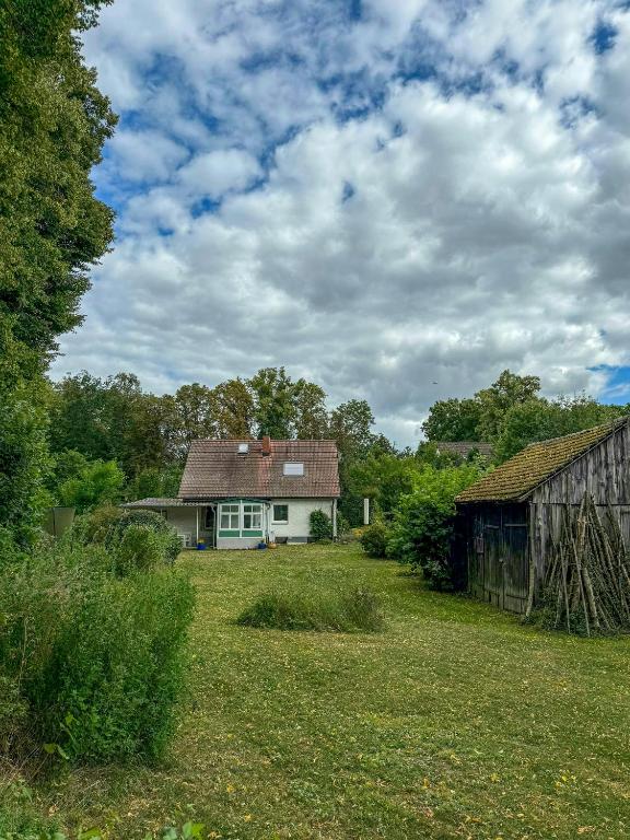 a house in the middle of a field at House Between Forest And Fields In Brandenburg in Casekow