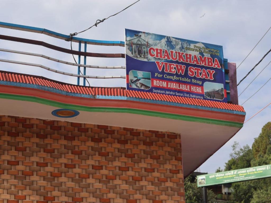 a sign on top of a brick building at Chaukhamba view stay in Gupta Kāshi