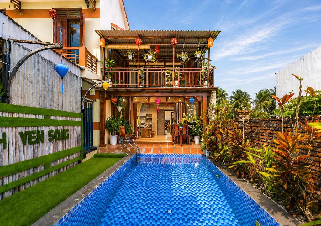 a house with a swimming pool in the yard at Family Private Villa Hội An in Hoi An