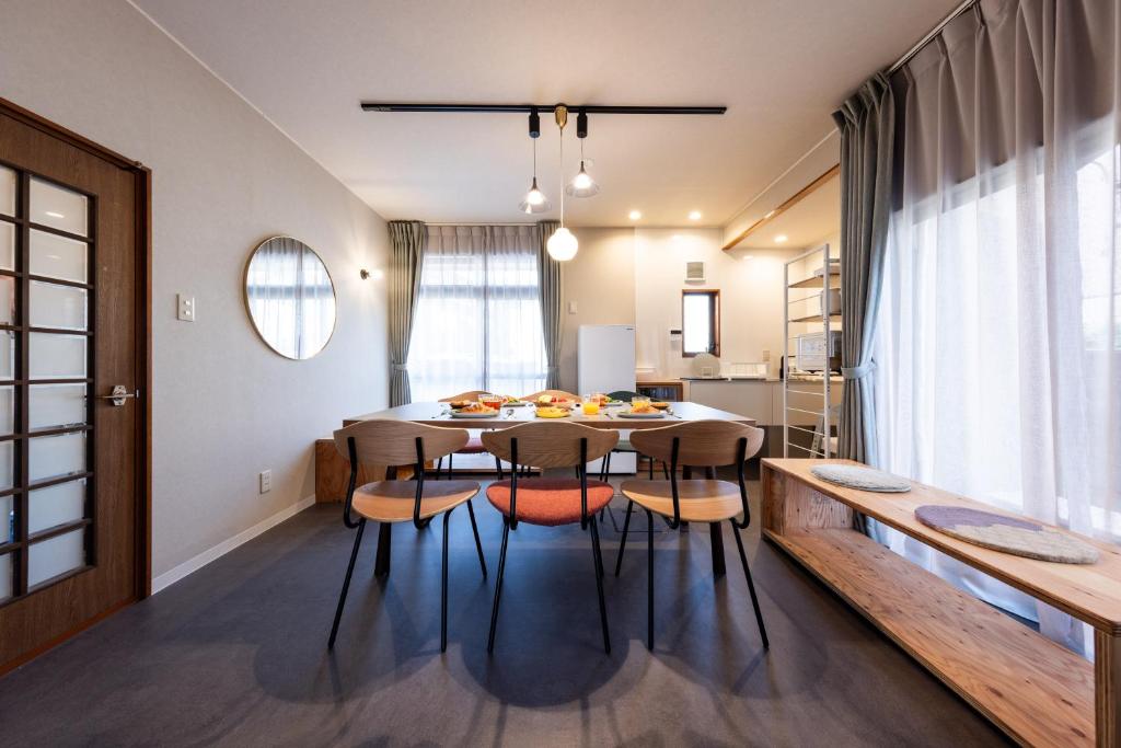a kitchen and dining room with a table and chairs at Ninifuni Kanazawa in Kanazawa