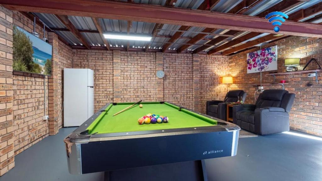 a garage with a pool table in a room at Coastal Crush in Callala Beach