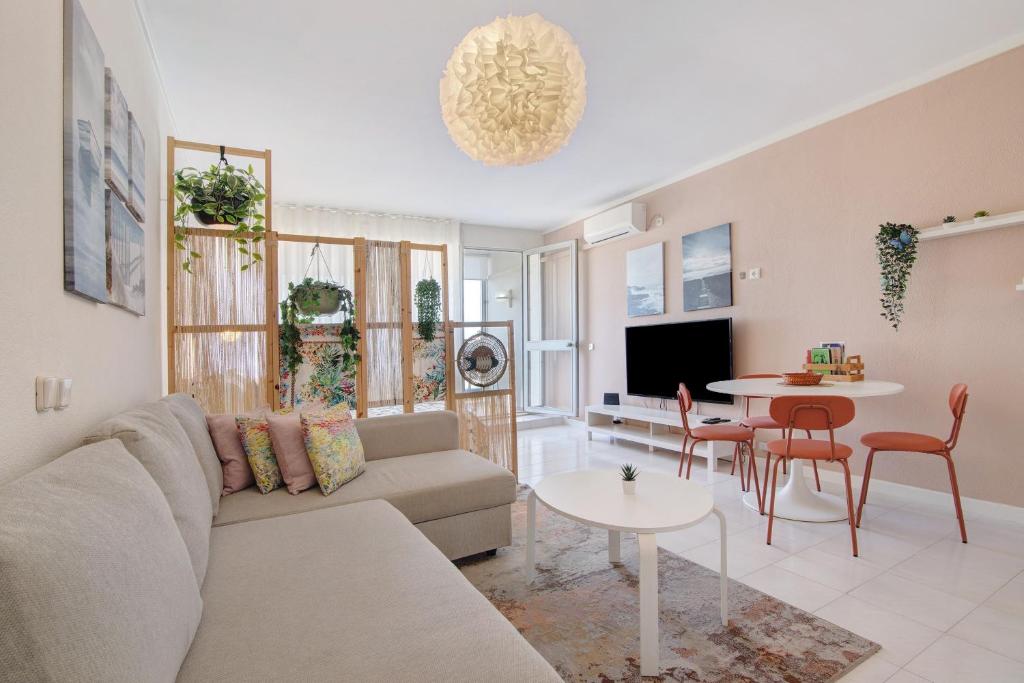 a living room with a couch and a table at Algarve Vilamoura Apartment in Quarteira