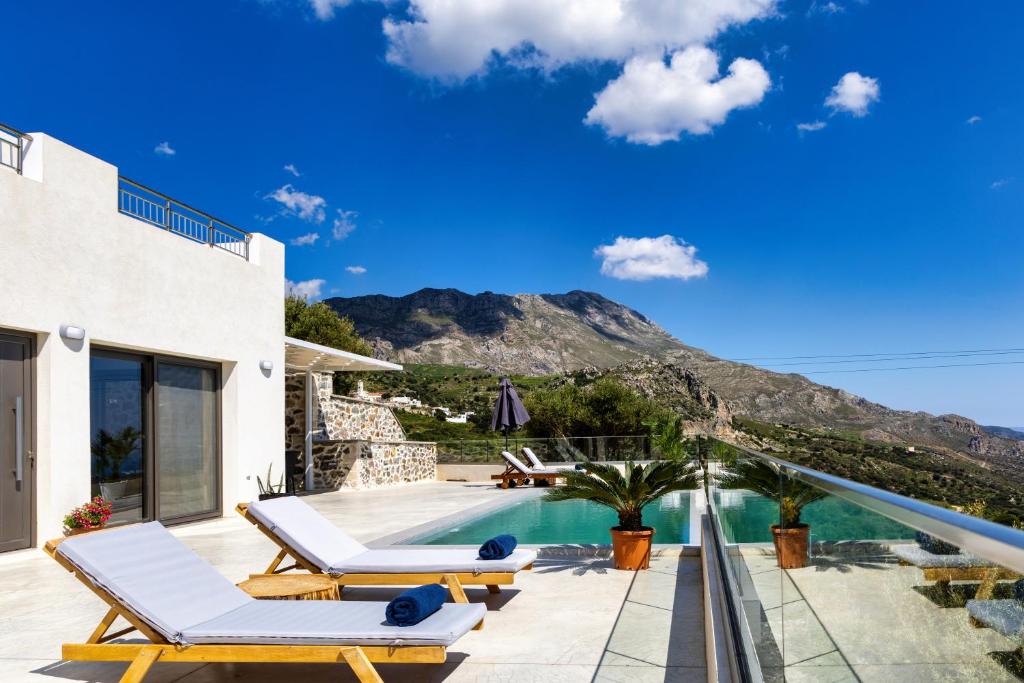 a villa with a swimming pool and a mountain at Kaliva Villa in Kerames