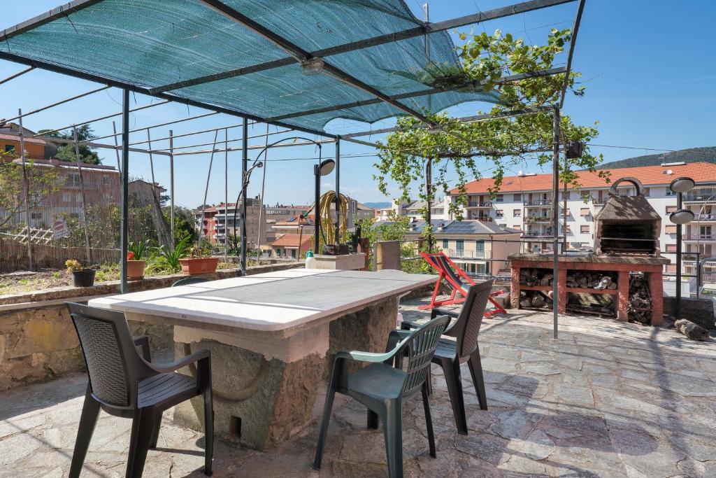 a large table and chairs on a patio with a view at Ca' Da Giuvanna in Sestri Levante
