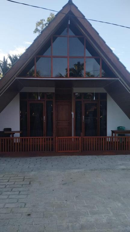 a large building with glass doors and a porch at Surf Logde katiet short motorcycle only minute from our places Bintang wave,Lance wave,HTs wave,monkeyWave in Katiet