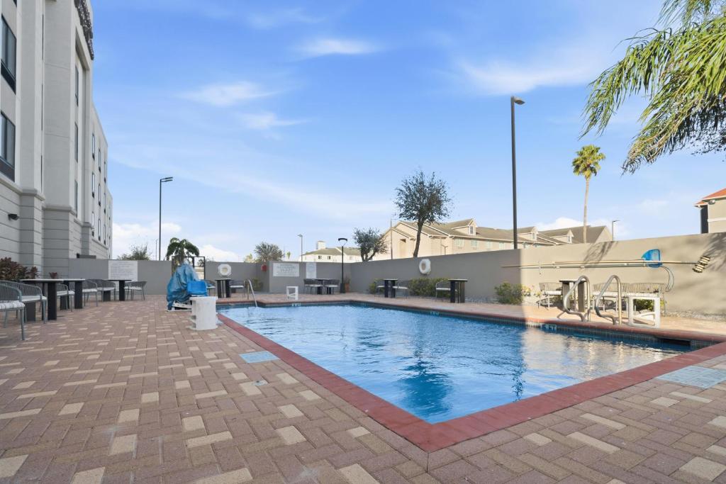 a swimming pool with a slide and a playground at Hampton Inn & Suites Pharr in Pharr