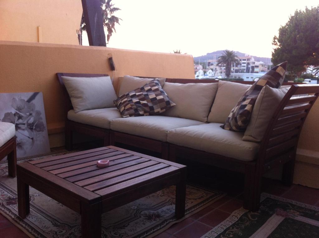 a living room with a couch and a coffee table at Au Coeur du Village Naturiste in Cap d'Agde