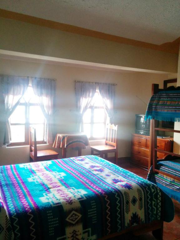 Postel nebo postele na pokoji v ubytování Hostal Curiñan