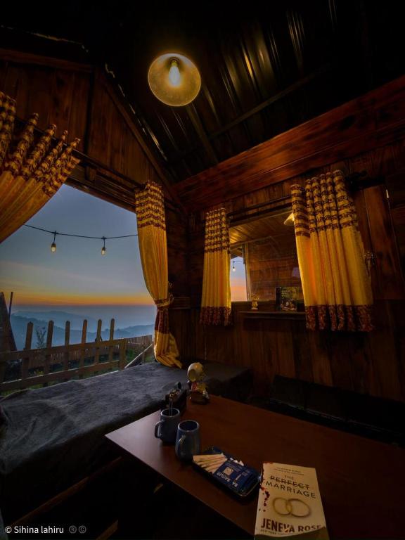a room with a table and a view of the ocean at Skyridge Infinity in Nuwara Eliya