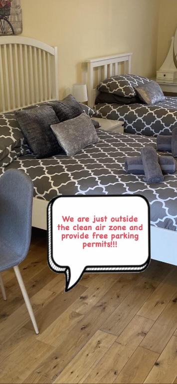 a bed with a sign that reads we are just outside the sign off ouripping at The Ashton Mews in Bristol