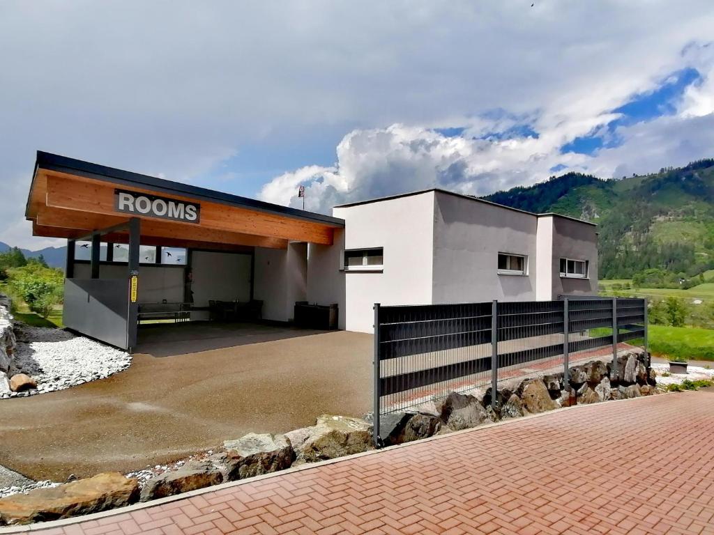 a gas station with a sign that reads rooms at Gästehaus Marion Appartements in Sankt Peter ob Judenburg