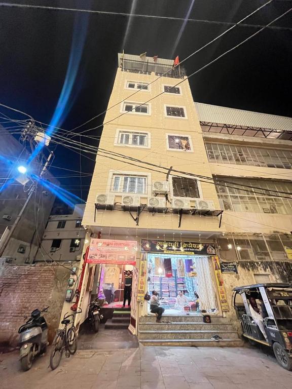 a tall building with a store in front of it at Maa Prabha Courtyard in Varanasi