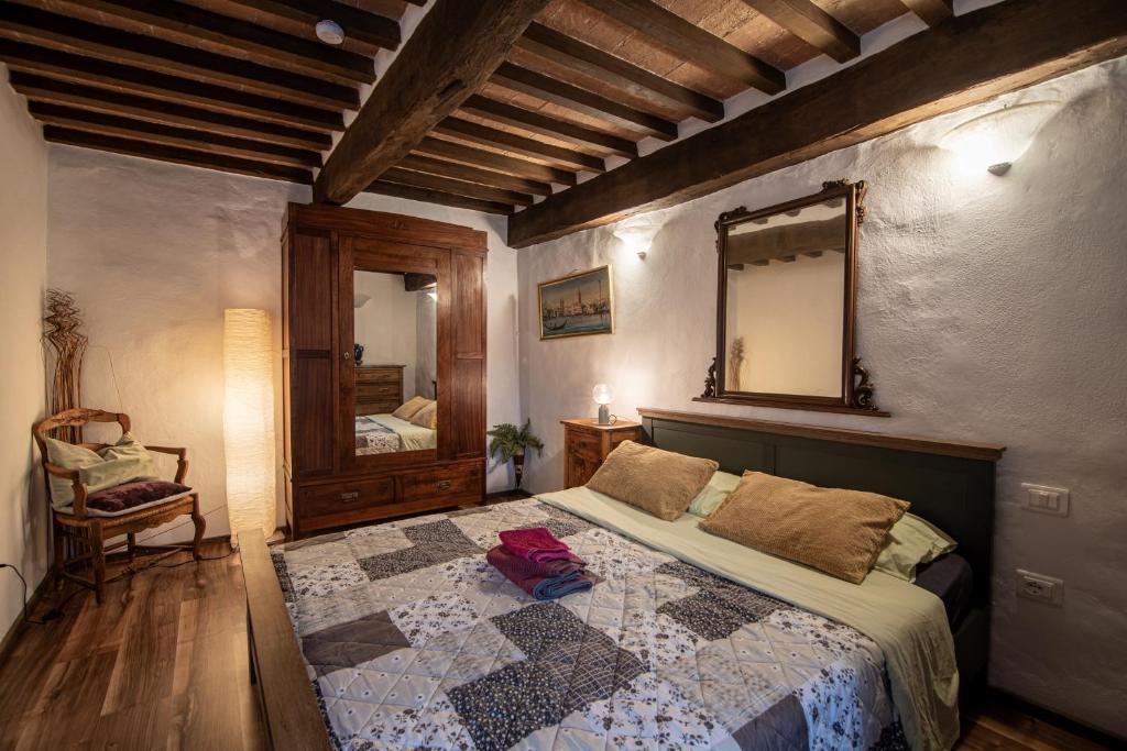 a bedroom with a bed with a quilt on it at Andrea's Nido in Castel del Piano