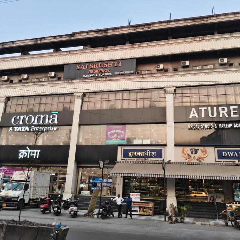 a large building with people standing outside of it at Sai Srushti Residency in Kalyan
