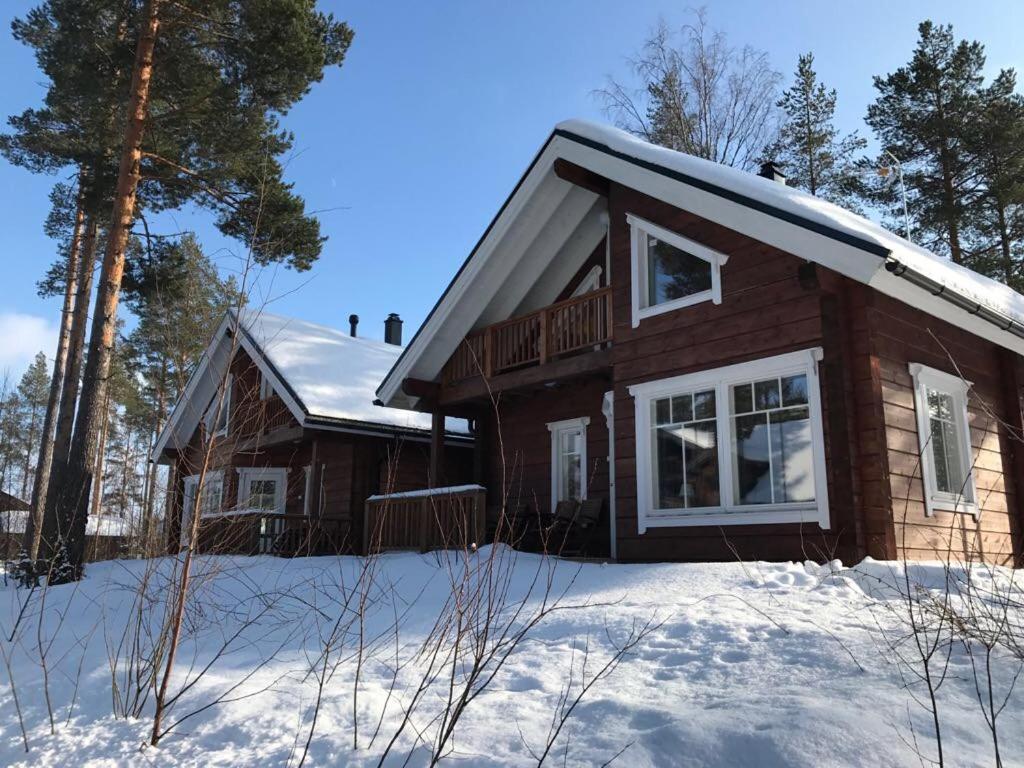 a wooden house in the snow with snow at PUTTITIE 4A in Tahkovuori