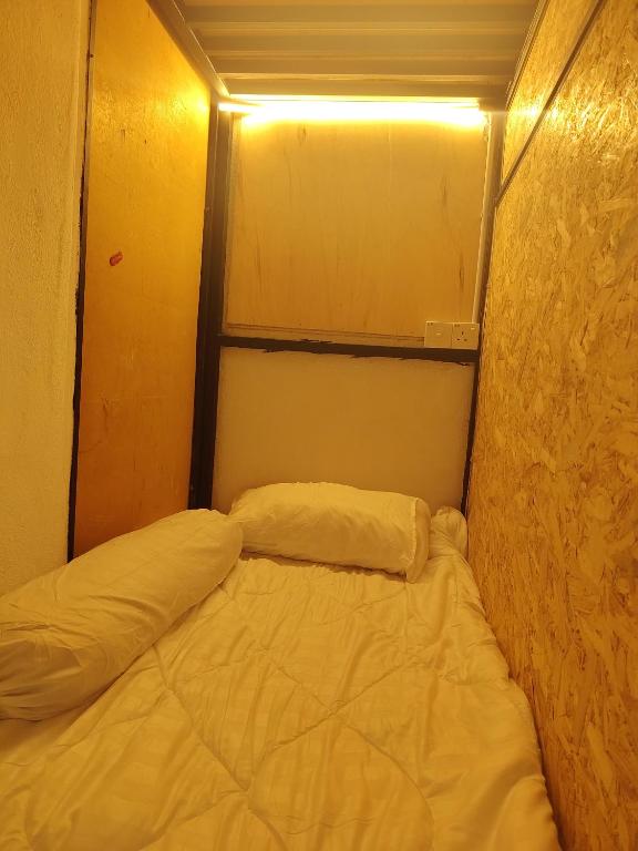 a small room with two beds in it at BM Homestay in Bukit Mertajam