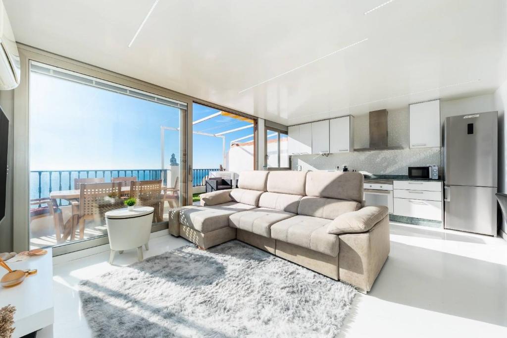 a living room with a couch and a kitchen at Tabarca’s View Santa Pola in Santa Pola