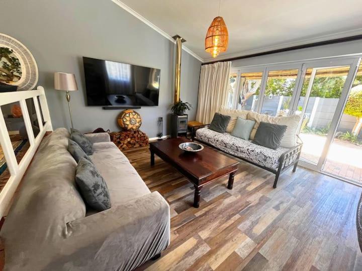 a living room with a couch and a table at Derby in Lakeside