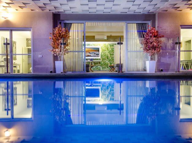 a swimming pool in a house with some flowers at כינור דוד המלך במנות in Manot