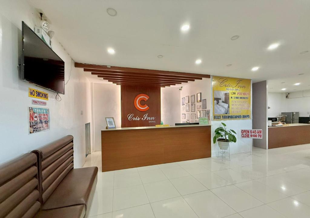 a waiting area of a dental office with a television at Cris Inn Samal in Samal