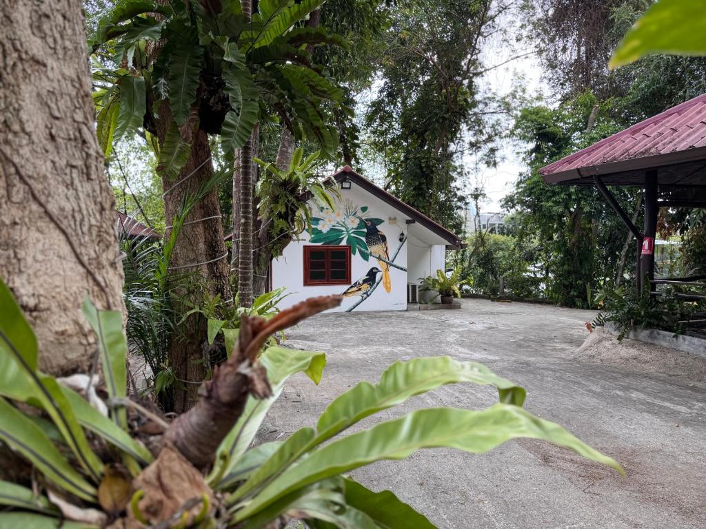 a white building with a tree in front of it at Pagi Pagi villas in Ao Nang Beach