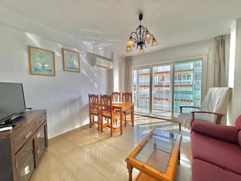 a living room with a couch and a table and chairs at Terrasol San Francisco 5ª Planta in Torre del Mar