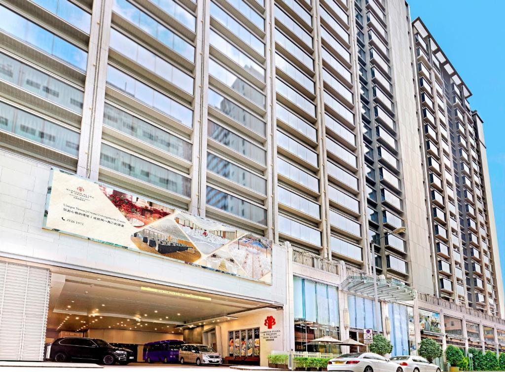a tall building with cars parked in front of it at Harbour Plaza 8 Degrees in Hong Kong