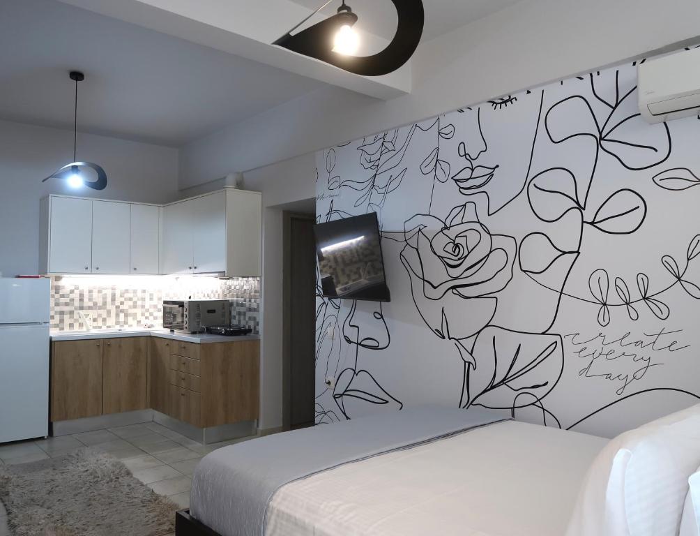 a bedroom with a wall with a drawing on it at BeCozy in Thérissos